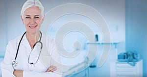 Portrait of caucasian senior female doctor smiling against hospital in background