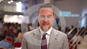 Portrait of caucasian speaker, business man, successful business leader, company executive on the background of the