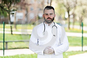 Portrait of a Caucasian Tired Exhausted Male Caucasian Doctor in the Park, Global Pandemic Outbreak