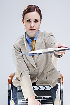 Portrait of Caucasian Woman in Blue Shirt and Tie Posing with Actioncut. Pointing Forward With Notepad photo