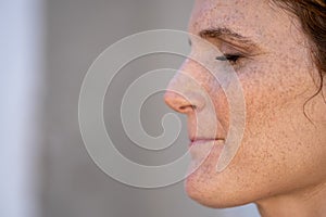 Portrait of a caucasian woman& x27;s face with freckles