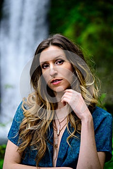 Portrait of a Caucasian woman standing against the Multnomah Falls in Oregon, Portland, USA