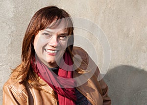 Portrait of a Caucasian Woman Wearing a Tan Leather Jacket and Red Scarf