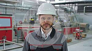 Portrait of caucasian young bearded professional male engineer man in hard hat