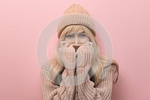 Portrait of Caucasian young woman wearing sweater over pink background