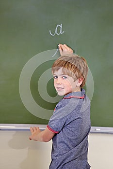 Portrait, chalk and boy drawing on a board for child development, confidence and art for learning. Academic, creative