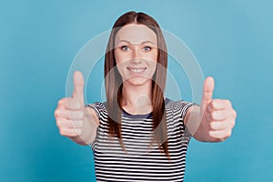 Portrait of charming cheerful cute adorable lady raise thumb up reliable agreement on blue background
