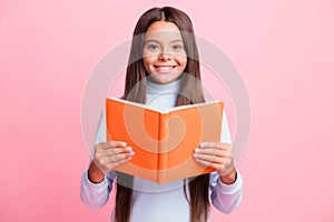 Portrait of charming content cheerful brainy brown-haired girl reading academic book isolated over pink pastel color