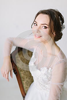 Portrait of a charming dark-haired bride, Studio, close-up. Wedding hairstyle and makeup. Young woman in luxurious