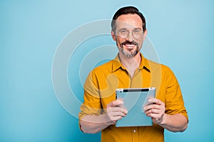 Portrait of charming mature man work on his tablet search social media news information wear modern outfit isolated over