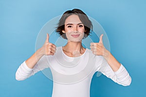 Portrait of charming positive lady showing thumb-up recommend offer product isolated on blue color background