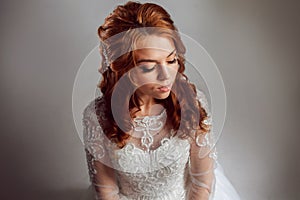 Portrait of a charming red-haired bride, Studio, close-up. Wedding hairstyle and makeup.