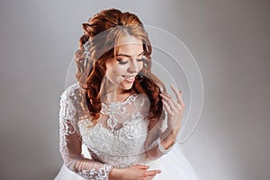 Portrait of a charming red-haired bride, Studio, close-up. Wedding hairstyle and makeup.