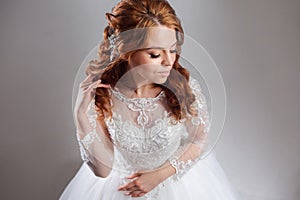 Portrait of a charming red-haired bride, Studio, close-up. Wedding hairstyle and makeup.