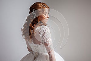 Portrait of a charming red-haired bride, Studio, close-up. Wedding hairstyle and makeup.