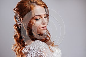 Portrait of a charming red-haired bride, Studio, close-up. Wedding hairstyle and makeup.