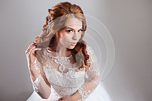 Portrait of a charming red-haired bride, Studio, close-up. Wedding hairstyle and makeup.