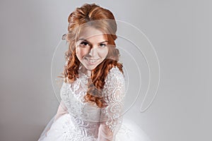 Portrait of a charming red-haired bride, Studio, close-up. Wedding hairstyle and makeup.