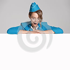 Portrait of charming stewardess wearing in blue uniform.