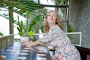 Portrait charming woman is calling, sitting alone in cafe in her free time