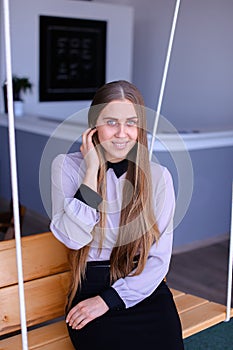 Portrait of charming young business woman looking at camera with