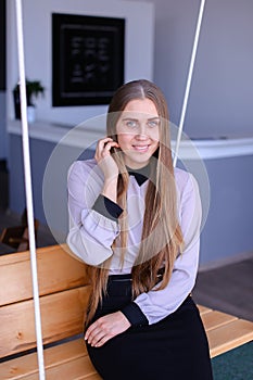 Portrait of charming young business woman looking at camera with