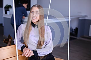 Portrait of charming young business woman looking at camera with