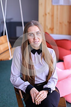 Portrait of charming young business woman looking at camera with
