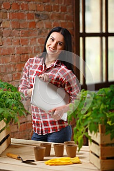 Portrait of a charming young female gardening