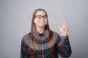 Portrait of charming young student woman pointing away