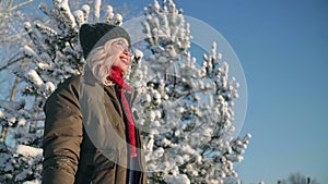 Portrait of charming young woman in forest in Christmas vacation, happy girl smiling and enjoying