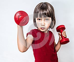 Portrait of cheeky pouting child raising dumbbells for feminism