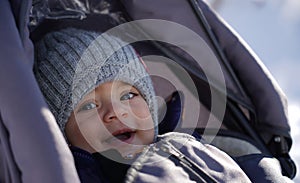 Portrait of cheerful adorable baby boy wearing knitted hat