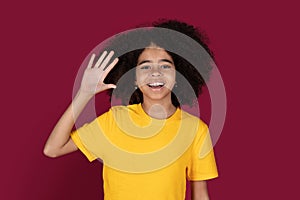 Portrait of cheerful african american kid girl waving at camera