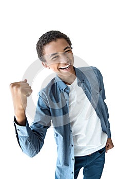 portrait of cheerful african american teenager with fist up