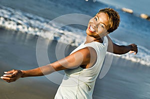Portrait of cheerful African American woman enjoying vacation on beach
