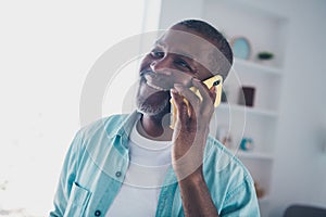 Portrait of cheerful aged man answer smart device call speak friend in modern house living room