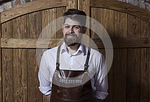 Portrait of cheerful bartender standing and smiling in bar befo photo
