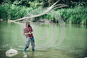 Portrait of cheerful bearded man fishing. Fisherman with fishing rod. Weekends made for fishing. Giving your hobby. With