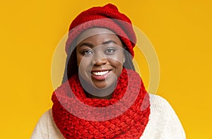 Portrait of cheerful black girl in red knitted winter set