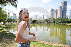 Portrait of cheerful Brazilian girl in Vaca Brava Park in Goiania, Goias, Brazil photo