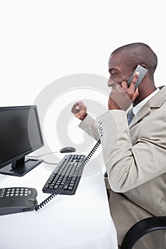 Portrait of a cheerful businessman making a phone call