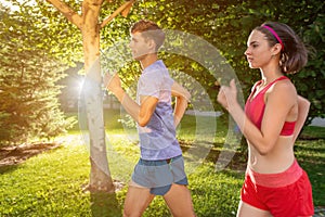 Portrait of cheerful caucasian couple running outdoors