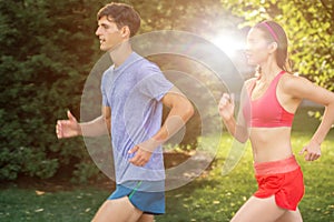 Portrait of cheerful caucasian couple running outdoors