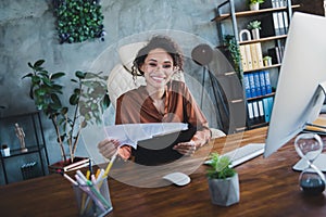 Portrait of cheerful elegant economist sitting chair hold clipboard documents annual review business center inside