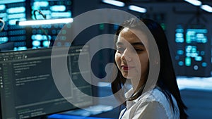 Portrait of cheerful engineer in data center installing software on computer