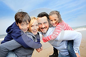 Portrait of cheerful family at the beach