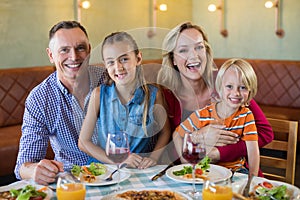 Portrait of cheerful family at restaurant