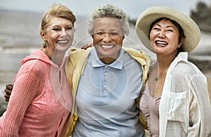 Portrait of cheerful female friends enjoying vacation at beach