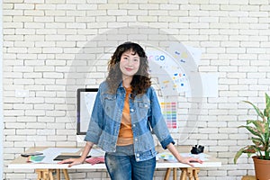 Portrait of cheerful female graphic designers in office. Creative people smiling at the camera during collaborative brainstorming